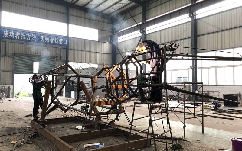 Welding the internal skeleton of the dinosaur.JPG